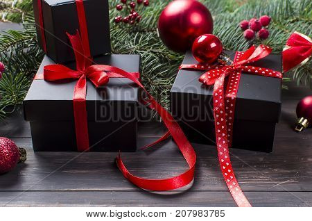 Black Christmas  Gift  Box With Red Ribbon And Fir Branches