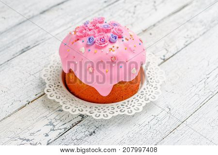 Traditional Easter bread or cake with decorations on wooden table