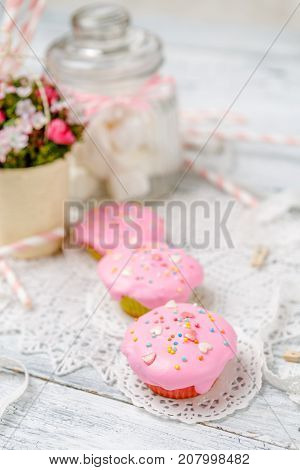 Traditional Easter cupcake with decorations and cupcakes on wooden table