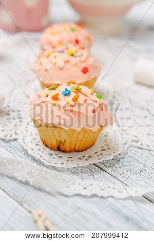 Traditional Easter cupcake with decorations and cupcakes on wooden table