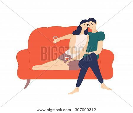 Cute Couple Sitting On Sofa And Drinking Wine During Romantic Date. Portrait Of Boyfriend And Girlfr