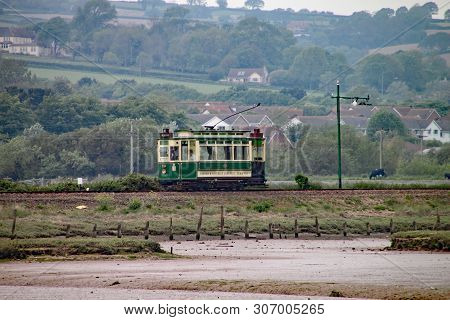 Seaton, Devon, England - May 22nd 2012: A Green Tram Travels Along The Seaton Tramway On Its Way To 
