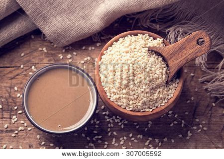Homemade sesam paste on a wooden background