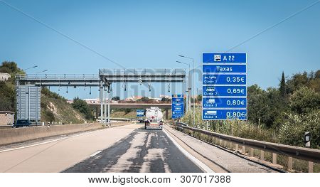 Faro, Portugal - May 4, 2018: Truck Passing Under A Tollgate On The Highway On A Spring Day