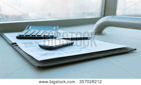 Calculator, Smartphone And Financial Documents On The Businessm