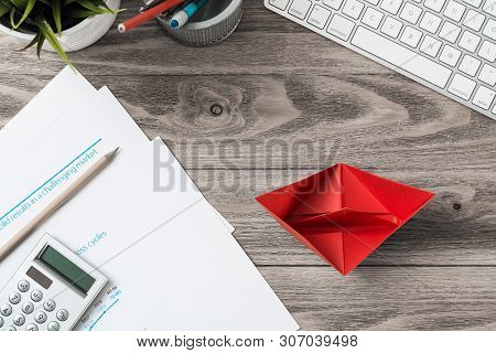 Businessman Workspace At Office Desk With Red Paper Ship. Top View Office Workplace Background. Flat