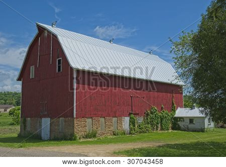Big Red Barn On A Sunny Day Roadside In Rural Wisconsin