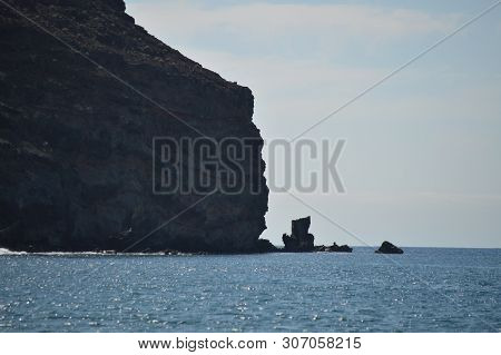 Wonderful Volcanic Cliff Beside The Black Sand Beach On A Sunny Day In The Great Tarajal. July 4, 20