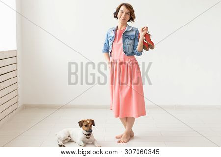 Clothing Designer, People, Pet Concept - Young Woman In Dress And Jeans Jacket With Jack Russell