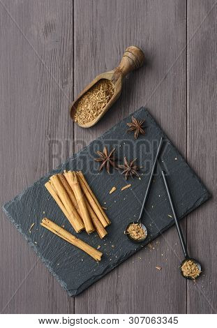 Cinnamon Stisk And Powder On The Wood Brown Table Anise Stars Rustic Close Up Spicy