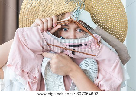 Woman Can Not Choose Which Clothes Pack For Travel. Clothing, Fashion, Style And People Concept - Wo