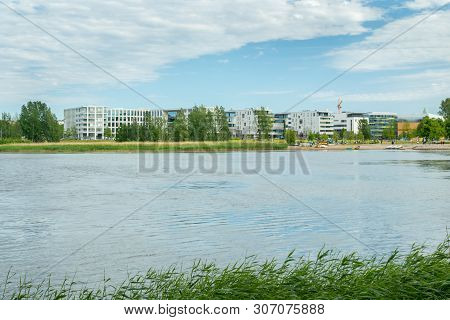 Helsinki, Finland - June 12, 2019: Toolo Bay In City Park. Across The Water Are New Residential Buil