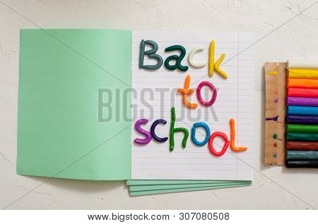 School Supplies And Inscription Back To School On Color Background