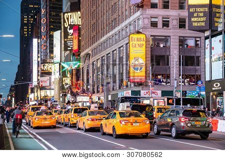 New York, Broadway Streets At Night. Colorful Neon Lights, Ads And People Walking