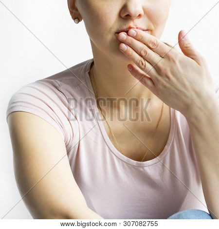 Red Bubbles Of Virus Herpes On Lips Of A Woman In Light Pink T-shirt, Lower Part Face Is Seen, Which