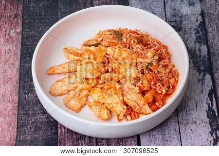 Fried Kimji With Skinless Chicken In Korean White Plate Served On Wood