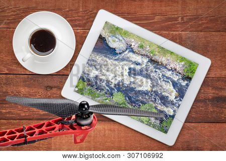 Poudre River and Canyon with high water and late spring scenery, reviewing an earial image on a digital tablet
