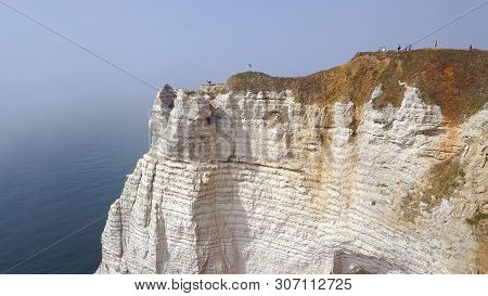 Top View Of Couple Walking Along Cliff Path. Action. Young Couple In Love Walks Along Narrow Path In