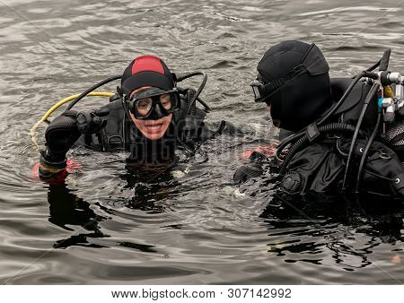 Scuba Diving In A Mountain Lake, Practicing Techniques For Emergency Rescuers. Immersion In Cold Wat