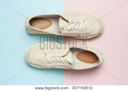 Beige Fashionable Women's Espadrilles On Color Pastel Blue Pink Background. Creative Concept Of Spri