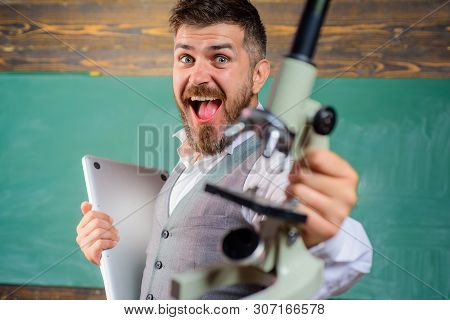 Positive Teacher With Computer And Microscope. Happy Bearded Man In Science Class. E-learning, Techn