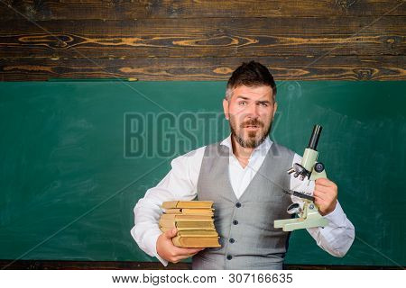 Education, Research, Knowledge&technology. Serious Male Teacher Holds Microscope. Student Doing Rese