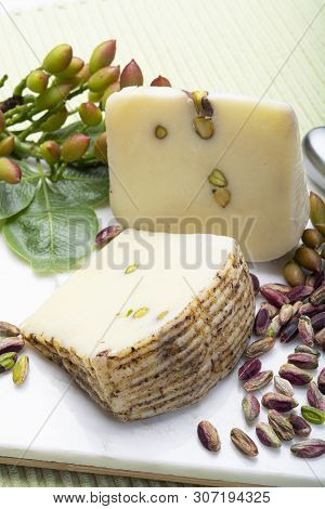 Italian Provolone Or Provola Cheese Made In Sicily With Tasty Green Bronte Pistachio Nuts Served On