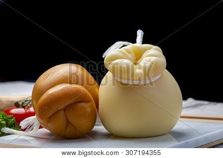 Italian Provolone Or Provola Caciocavallo Hard And Smoked Cheeses In Teardrop Form Served On White M