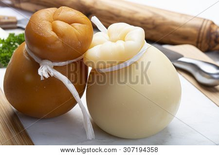 Italian Provolone Or Provola Caciocavallo Hard And Smoked Cheeses In Teardrop Form Served On White M