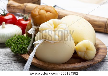 Italian Provolone Or Provola Caciocavallo Hard And Smoked Cheeses In Teardrop Form Served On Olive T