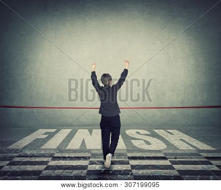 Rear View Winning Young Woman Celebrate Raising Hands Up Crossing The Finish Line, Breaking The Red 