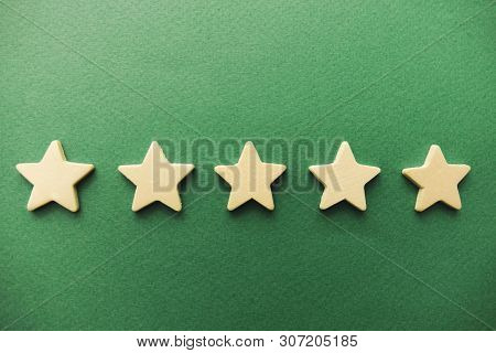 Five White Stars On A Green Background