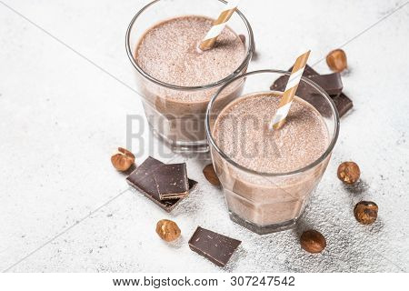 Chocolate Coconut Hazelnut Milkshake Or Smoothie In Two Glasses On White Stone Table.