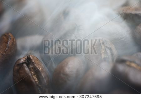 Arabica Coffee Background. Roasted Coffee Beans With Smoke .close Up.