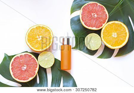 Cosmetic Flat Lay With Vitamin C Serum And Citrus On The White Background. Top View