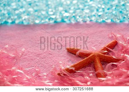 Microplastic pollution in ocean sea concept pink starfish on the beach