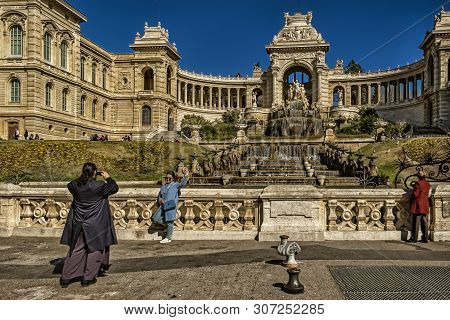 Marseilles, France, March 2019, tourist being photographed in front of the “Beaux Arts” museum
