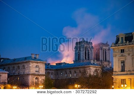 Paris, France - April 15th, 2019 : Notre-dame Still Burning At Night, A Few Hours After The Beginnin