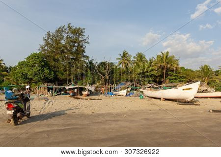 Goa, India - December 20, 2018: Fishermen Prepare Tackle And Boats On Morjim Beach