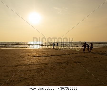 Goa, India - December 20, 2018: Fishermen Fishing With Nets On Morjim Beach