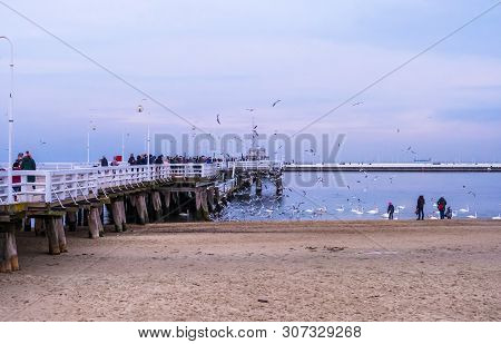 Sopot, Poland - February 06, 2019: The Sopot Pier Is The Longest Wooden Pier In Europe. People Walk 
