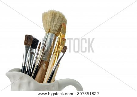 Various Professional Paint Brushes In The Porceline Vase, White Background, Isolated