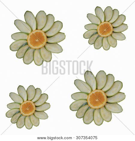 Slices Of Orange And Zucchini In The Shape Of A Flower. Isolated On White Background. Four Chamomile