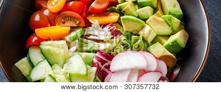 Vegan Buddha Bowl. Bowl With Fresh Raw Vegetables - Cherry Tomatoes, Cucumber, Radish, Avocado, Lett