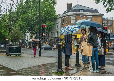 London, Uk - Jun 5, 2019 : Pedestrians Protect Themself From The Rain With Umbrellas During A Rainfa