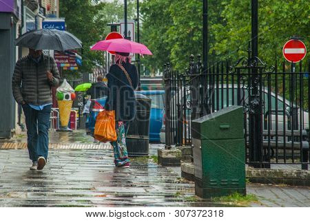 London, Uk - Jun 5, 2019 : Pedestrians Protect Themself From The Rain With Umbrellas During A Rainfa