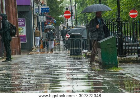 London, Uk - Jun 5, 2019 : Pedestrians Protect Themself From The Rain With Umbrellas During A Rainfa