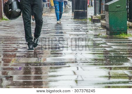 London, Uk - Jun 5, 2019 :  Pedestrian Feet Walking In The Rain In Chiswick Street.
