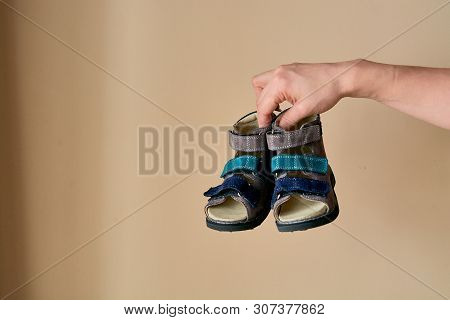 Female Is Holding Close-up A Special Childrens Orthopedic Shoe Sandals Made Of Genuine Leather.