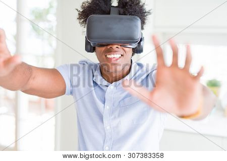 African amaerican man having fun playing with virtual reality glasses